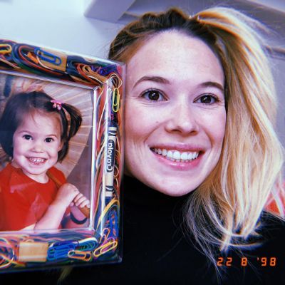 Celina Sinden holding a picture of her young self.